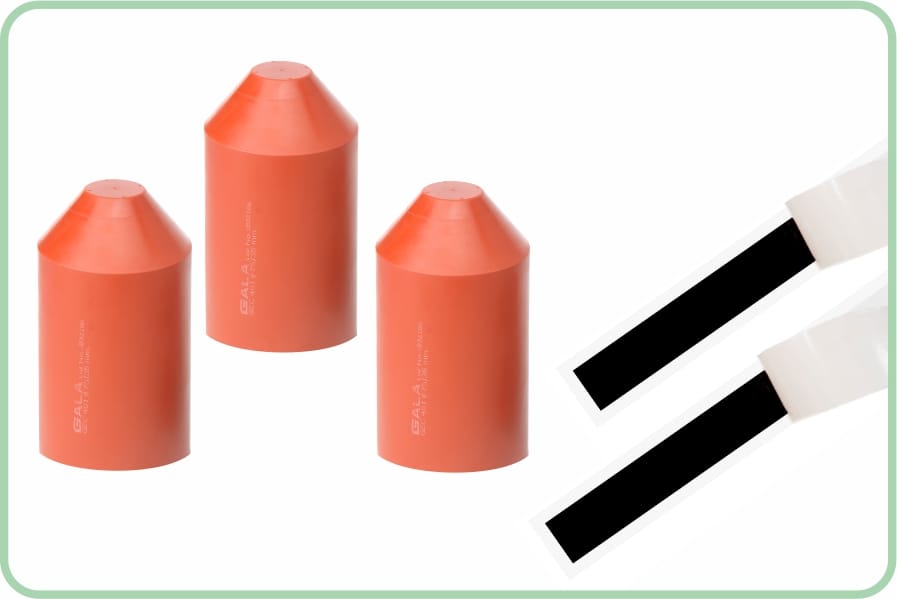 Three red heat-shrink domed bushing end caps moulded with the GALA mark, shown beside two strips of black sealing mastic on white backing paper.